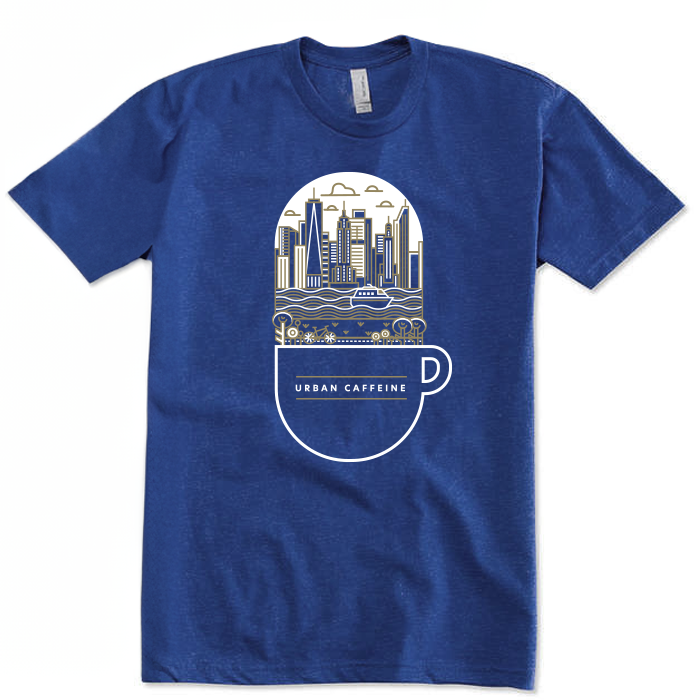 Blue t-shirt with on the front graphic design of New York City skyline with a river, ferry, and bike trail coming out of a cup mug with the words Urban Caffeine